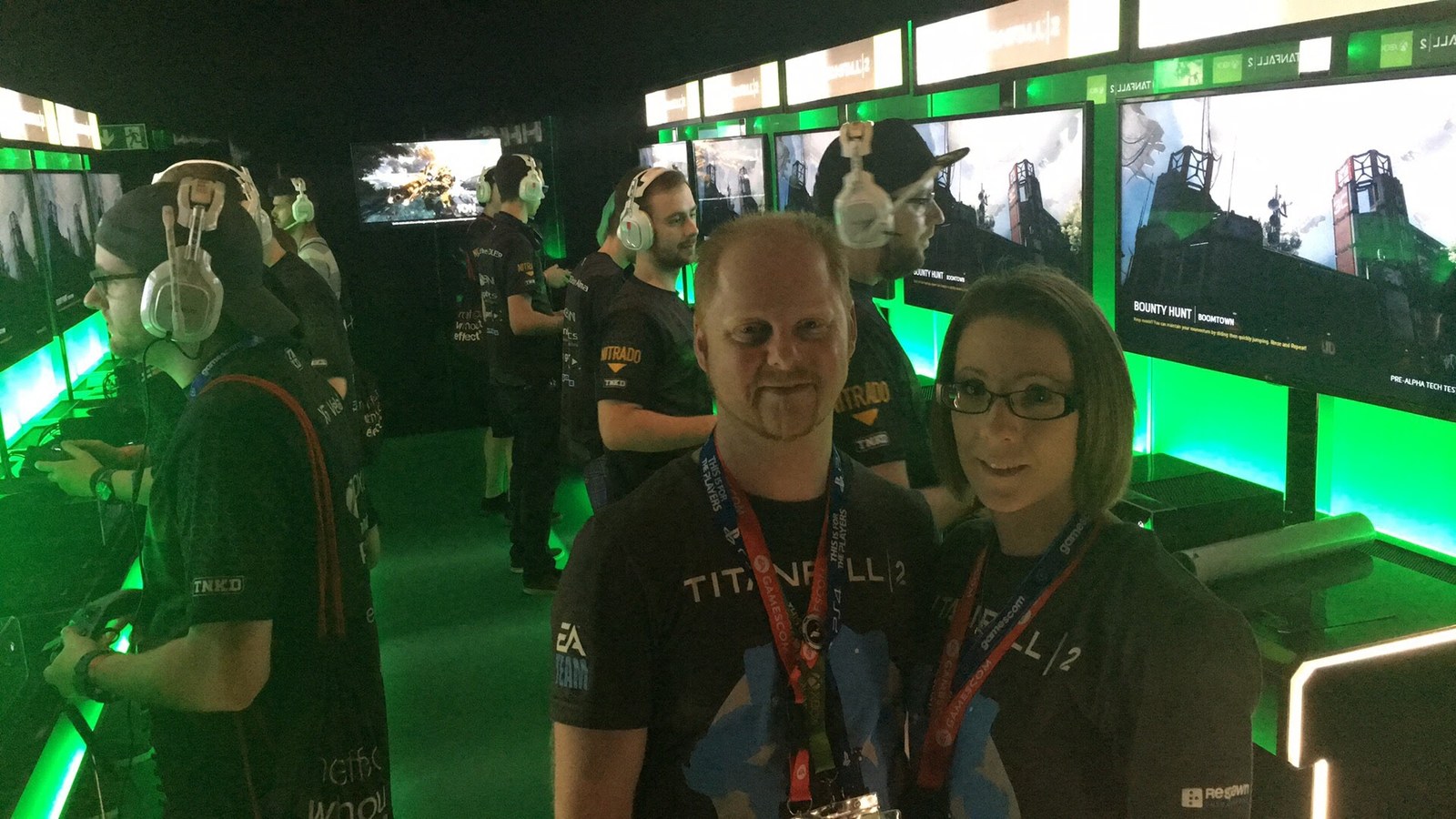 Oz at the Titanfall 2 stand at Gamescom in 2016, with the game running on screens behind.